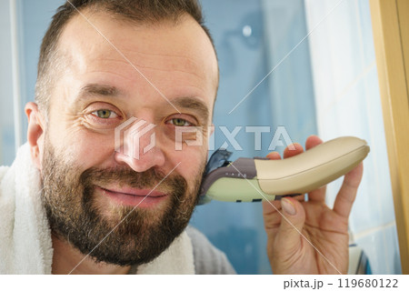 Man shaving trimming his beard 119680122