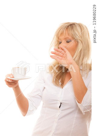 Sleepy tired woman yawning holds cup of coffee 119680229