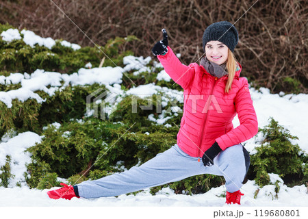 Woman wearing sportswear exercising outside during winter Woman wearing sportswear exercising outside during winter 119680801