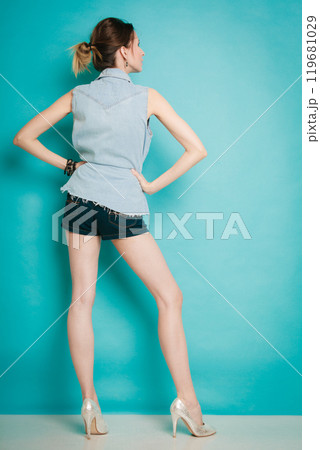 Summer fashion girl in jeans shirt shorts and high heels. 119681029
