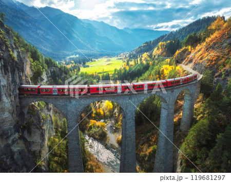 Aerial view of red train on Landwasser viaduct in autumn in Alps Aerial view of red train on Landwasser viaduct in autumn in Alps 119681297