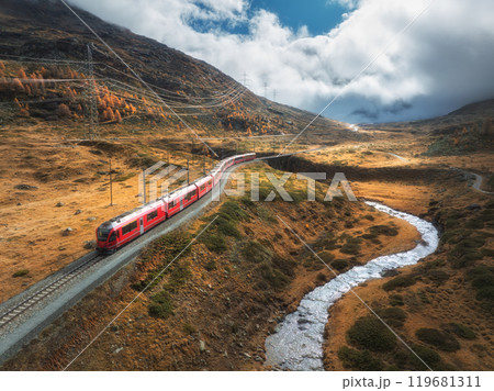 Aerial view of red train, river, mountains, orange hills in fall 119681311