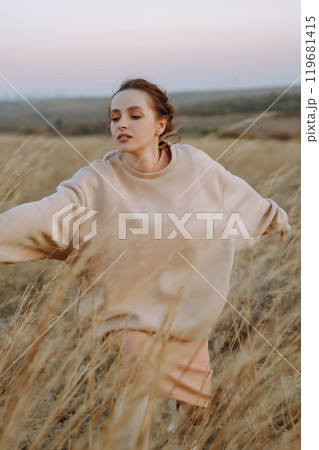 Young woman enjoys autumn day. People, lifestyle, travel, nature and vacations concept. 119681415
