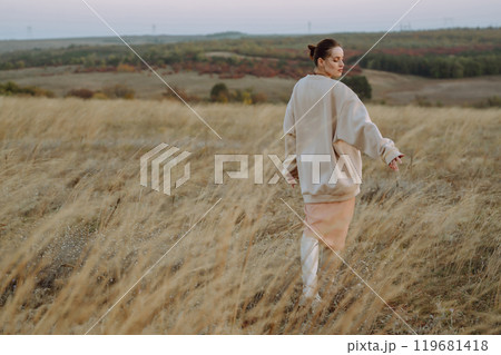 Young woman enjoys autumn day. People, lifestyle, travel, nature and vacations concept. Young woman enjoys autumn day. People, lifestyle, travel, nature and vacations concept. 119681418