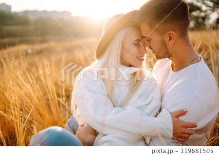 Young couple having fun walking and hugging n the park. Autumn weather. Relaxation, youth. Young couple having fun walking and hugging n the park. Autumn weather. Relaxation, youth. 119681505