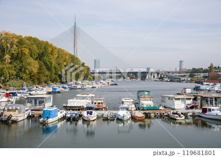 Boat marina at Ada Ciganlija with Ada Bridge, a cable-stayed bridge over the Sava river in Belgrade, Serbia 119681801
