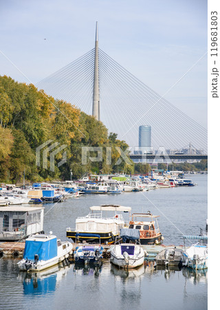 Boat marina at Ada Ciganlija with Ada Bridge, a cable-stayed bridge over the Sava river in Belgrade, Serbia 119681803
