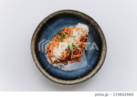Classic spaghetti Bolognese topped with Parmesan, comforting and flavorful Italian meal 119682660