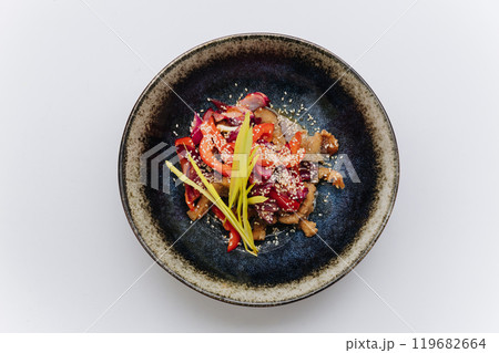 Stir fried vegetables and meat topped with sesame seeds, creating a vibrant and flavorful Asian dish Stir fried vegetables and meat topped with sesame seeds, creating a vibrant and flavorful Asian dish 119682664