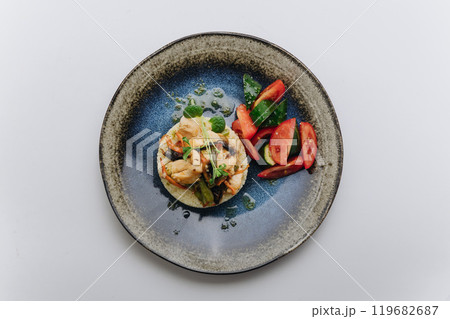 Grilled chicken with vegetables and fresh tomato cucumber salad for a healthy and balanced meal 119682687