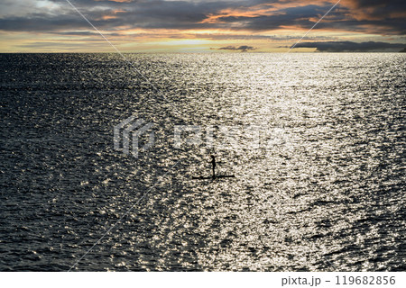 Silhouette of a woman practicing paddle surfing in Menorca at sunset. Balearic Islands 119682856