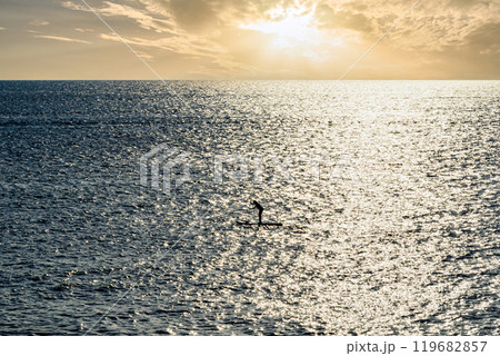 Silhouette of a woman practicing paddle surfing in Menorca at sunset. Balearic Islands 119682857