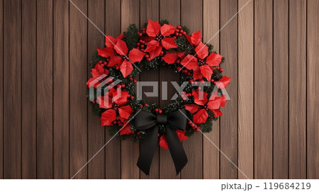 A wreath of red poinsettias is hanging on a wooden wall 119684219
