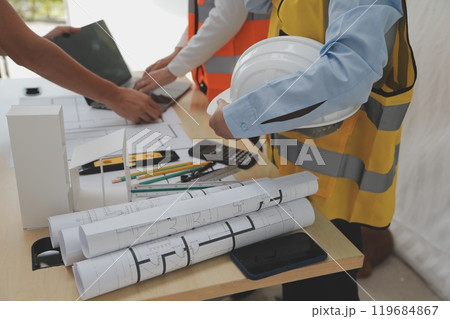 Construction and structure concept of Engineer or architect meeting for project working with partner and engineering tools on model building and blueprint in working site, contract for both companies. 119684867