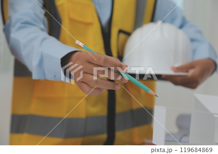 Construction and structure concept of Engineer or architect meeting for project working with partner and engineering tools on model building and blueprint in working site, contract for both companies. 119684869