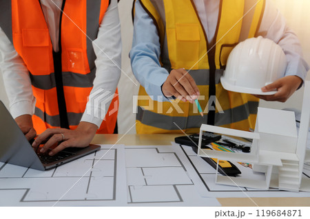 Construction and structure concept of Engineer or architect meeting for project working with partner and engineering tools on model building and blueprint in working site, contract for both companies. 119684871