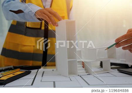 Construction and structure concept of Engineer or architect meeting for project working with partner and engineering tools on model building and blueprint in working site, contract for both companies. Construction and structure concept of Engineer or architect meeting for project working with partner and engineering tools on model building and blueprint in working site, contract for both companies. 119684886