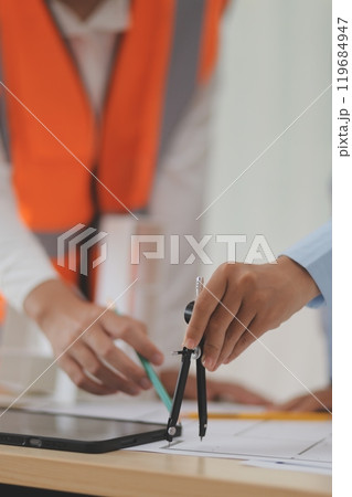 Construction and structure concept of Engineer or architect meeting for project working with partner and engineering tools on model building and blueprint in working site, contract for both companies. Construction and structure concept of Engineer or architect meeting for project working with partner and engineering tools on model building and blueprint in working site, contract for both companies. 119684947