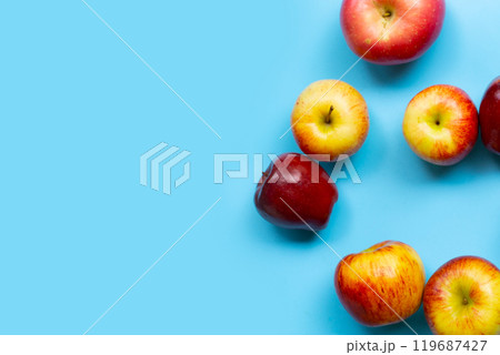 Variety of fresh apples on blue background. 119687427