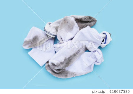Dirty white socks on blue background. 119687589