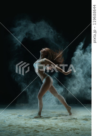 Slim blonde in lingerie in dust profile shot Slim blonde in lingerie in dust profile shot 119688644