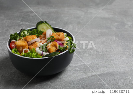 Fried tofu salad in a bowl close-up 119688711