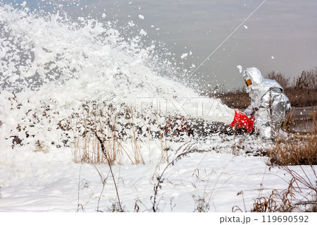 Firemen pouring flame with firefighting foam Firemen pouring flame with firefighting foam 119690592