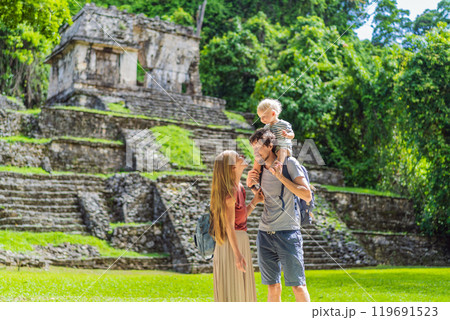 Mom, dad and baby son exploring the ancient pyramids of Palenque, Mexico, surrounded by dense jungle. Cultural heritage and adventure travel concept Mom, dad and baby son exploring the ancient pyramids of Palenque, Mexico, surrounded by dense jungle. Cultural heritage and adventure travel concept 119691523
