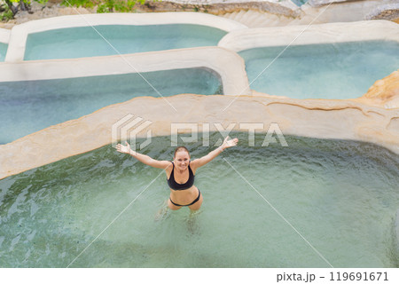 Female tourist at the hot springs of Grutas Tolantongo, Mexico. Adventure, relaxation, and natural wellness concept Female tourist at the hot springs of Grutas Tolantongo, Mexico. Adventure, relaxation, and natural wellness concept 119691671