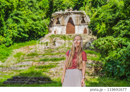 Female tourist exploring the ancient pyramids of Palenque, Mexico, surrounded by dense jungle. Cultural heritage and adventure travel concept 119691677