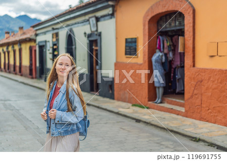Female tourist walks through the colonial streets San Cristobal de las Casas, Mexico. Cultural exploration, architecture, and travel experience concept 119691755