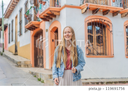 Female tourist walks through the colonial streets San Cristobal de las Casas, Mexico. Cultural exploration, architecture, and travel experience concept 119691756