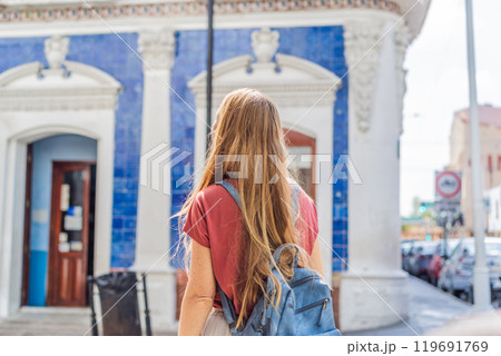 Female tourist in front of Casa de los Azulejos in Villahermosa, Mexico. Quintana Roo travel, cultural exploration, and historic architecture concept 119691769