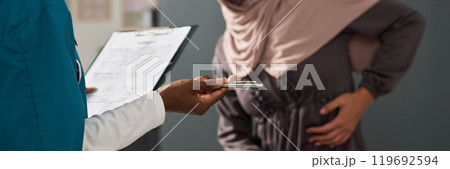 Holding Clipboard and Pen While Discussing With Muslim Patient 119692594