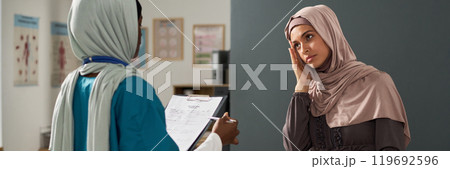 Consulting With Muslim Healthcare Professional in Medical Office 119692596