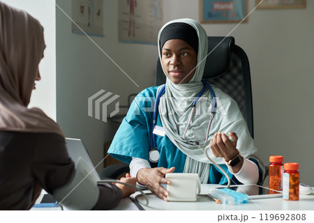 Muslim Healthcare Professional Checking Blood Pressure in Clinic Muslim Healthcare Professional Checking Blood Pressure in Clinic 119692808