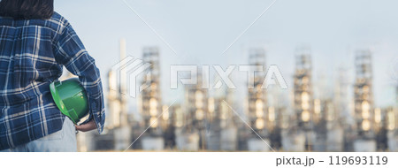 Banner Woman worker hands holding hardhat yellow work helmet Construction Engineer. Panorama Refinery woman worker industry hand hold yellow worker helmet hard hat. Refinery industry with copy space 119693119