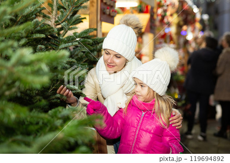 Friendly family of mother and daughter having fun on outdoor fair Friendly family of mother and daughter having fun on outdoor fair 119694892
