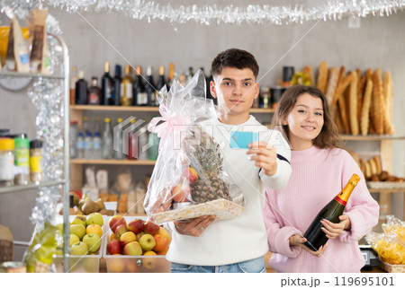 Young couple enjoying holiday shopping with credit card Young couple enjoying holiday shopping with credit card 119695101