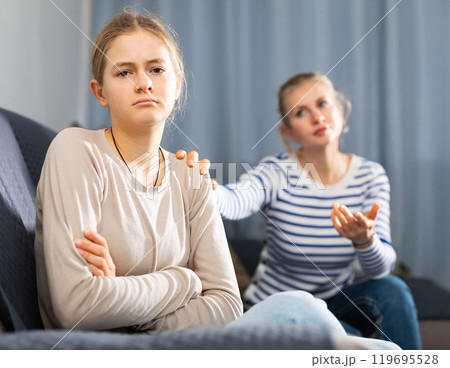 Mother soothes teen daughter after an quarrel Mother soothes teen daughter after an quarrel 119695528