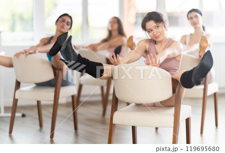 Sitting on chair, girl train to perform lap dance, interacting with imaginary partner 119695680