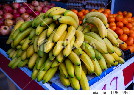 Fresh bananas on the counter in supermarket, nobody Fresh bananas on the counter in supermarket, nobody 119695960