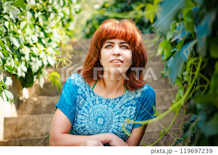 The girl with the red hair in the leaves The girl with the red hair in the leaves 119697239