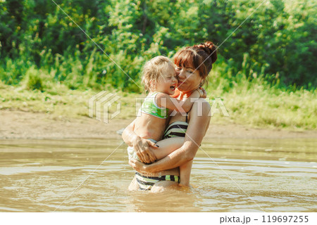 mom and child swim in the river mom and child swim in the river 119697255