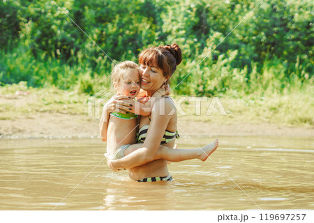 mom and child swim in the river mom and child swim in the river 119697257