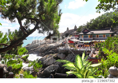 Pavilions of Haedong Yonggungsa temple and Three-story pagoda on a rocky seashore, Busan, South Korea. Sea sceneries with Haedong Yonggung temple with ancient stone pagoda 119697302