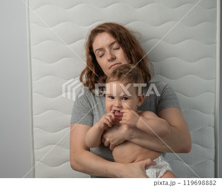 Top view of unhappy mother and little child in bed. Top view of unhappy mother and little child in bed. 119698882
