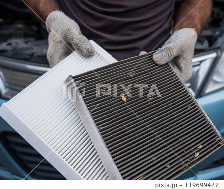 The master changes the cabin air filter of the car. 119699427