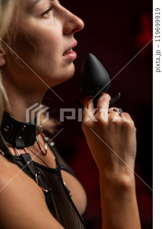 Caucasian woman holding silicone anal plug. Caucasian woman holding silicone anal plug. 119699919