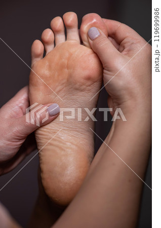 Close-up of a woman's foot massage. Vertical photo. 119699986